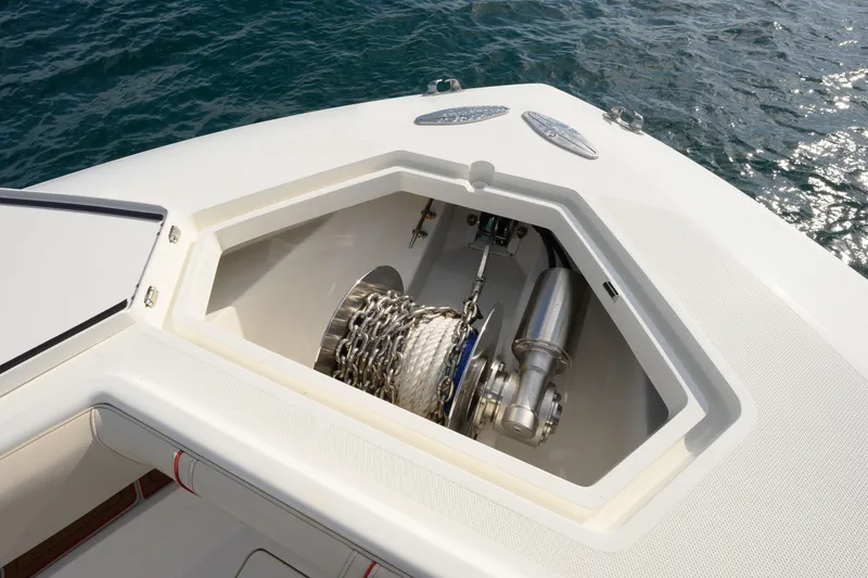 Slide: The Image of Anchor compartment of 2022 SeaVee 450Z boat with chain and rope, near water. - 15