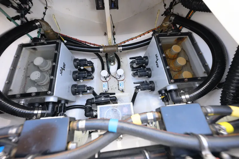 Slide: The Image of Engine compartment of 2022 SeaVee 450Z boat, showcasing mechanical components and wiring. - 17