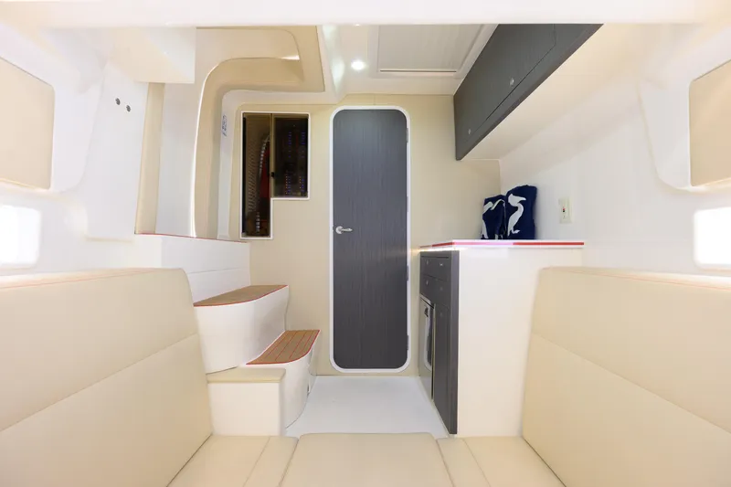 Slide: The Image of Interior of 2022 SeaVee 450Z boat, featuring modern seating and cabinetry. - 19