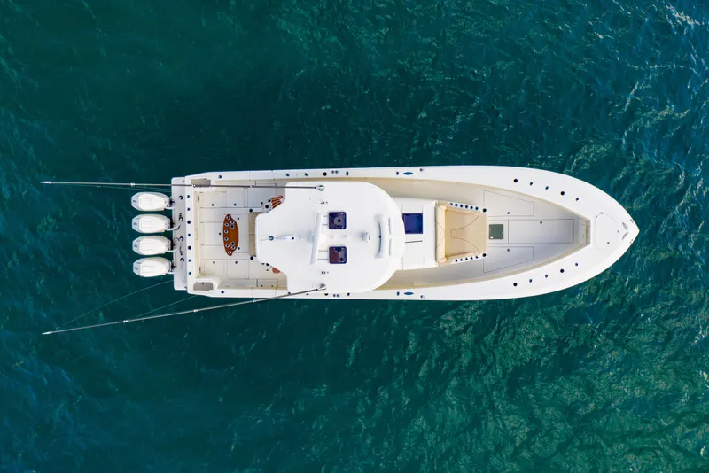 Slide: The Image of Top view of 2022 SeaVee 450Z boat on clear blue water. - 2