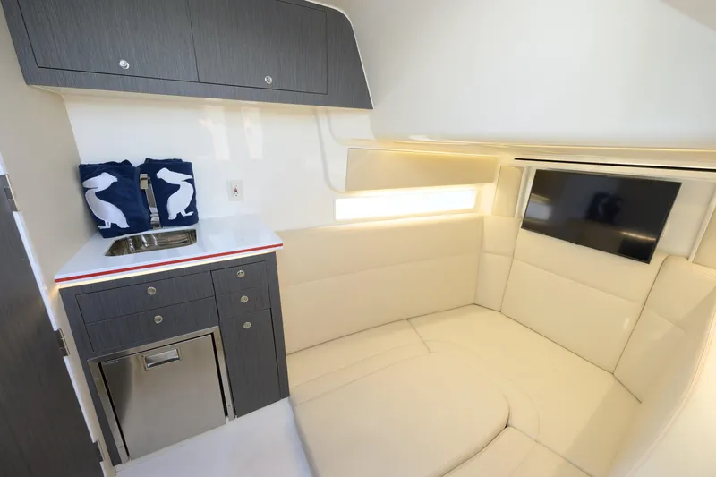 Slide: The Image of Luxurious interior of 2022 SeaVee 450Z boat with seating, TV, and kitchenette. - 21
