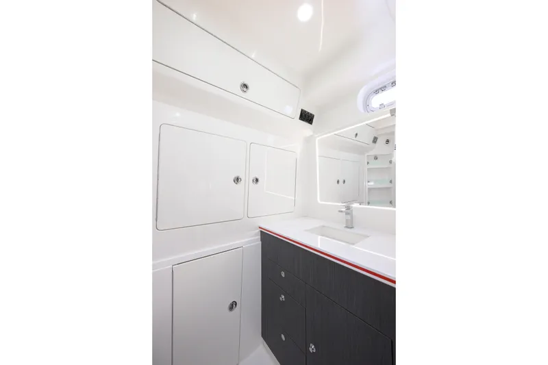Slide: The Image of 2022 SeaVee 450Z boat interior bathroom with modern cabinetry and sleek design. - 22