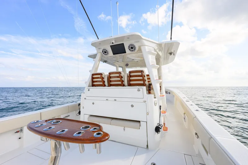 Slide: The Image of 2022 SeaVee 450Z boat deck with seating, ocean view, and clear sky. - 7