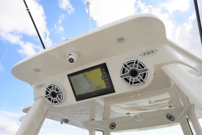 Slide: The Image of 2022 SeaVee 450Z boat console with speakers and navigation screen under blue sky. - 9