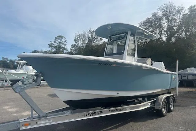 Slide: The Image of 2024 Sea Hunt Ultra 239 SE boat on trailer, parked outdoors. - 2