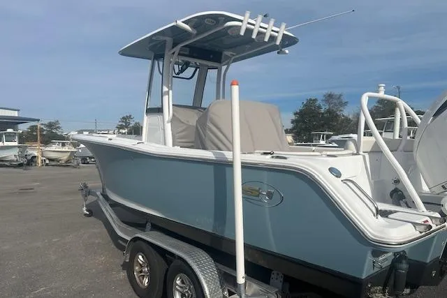 Slide: The Image of 2024 Sea Hunt Ultra 239 SE boat on trailer, parked outdoors. - 3