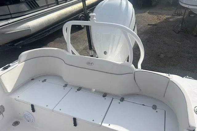 Slide: The Image of 2024 Sea Hunt Ultra 239 SE boat interior with seating and engine view. - 8