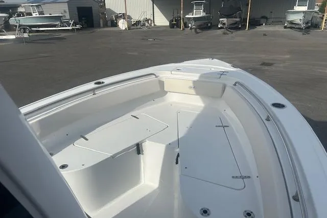 Slide: The Image of 2024 Sea Hunt Ultra 239 SE boat interior, spacious deck with seating and storage. - 9