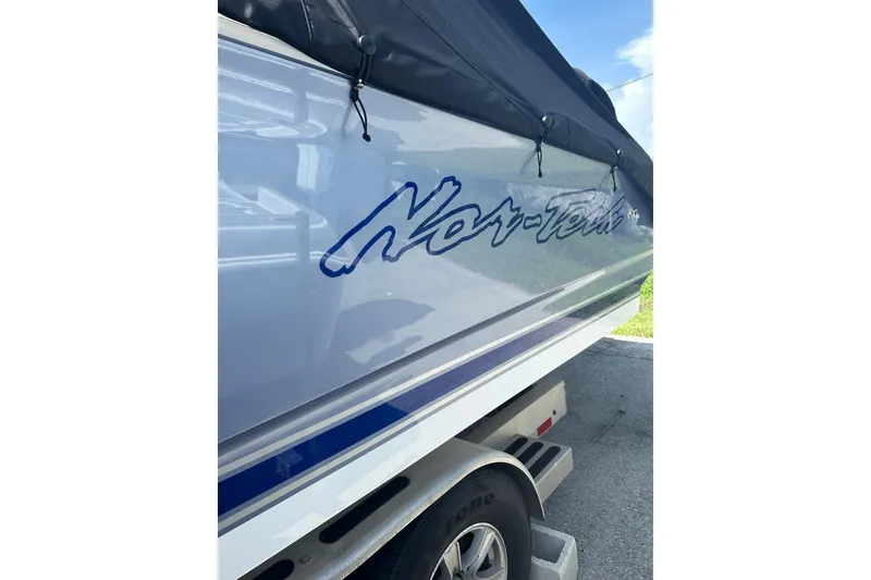Slide: The Image of 2024 Nor-Tech 340 Sport Center Console boat on trailer, side view with logo. - 18