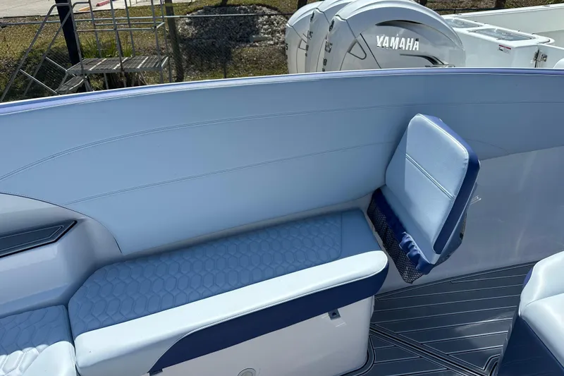 Slide: The Image of 2024 Nor-Tech 340 Sport Center Console interior with blue seating and Yamaha engine. - 3