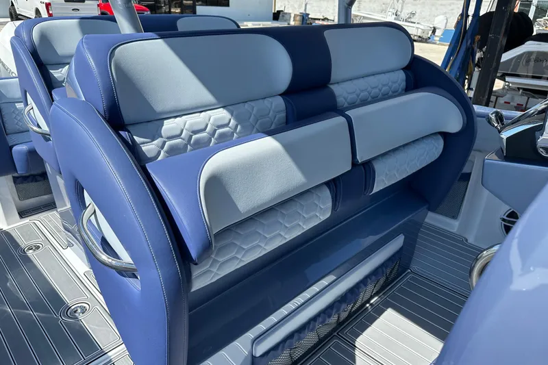 Slide: The Image of 2024 Nor-Tech 340 Sport Center Console interior with blue and gray seating. - 4