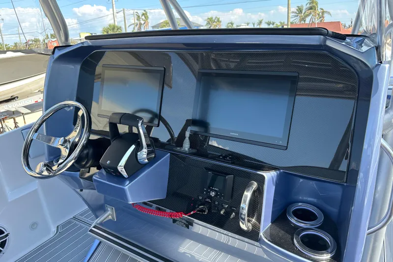 Slide: The Image of 2024 Nor-Tech 340 Sport Center Console dashboard with dual screens and modern controls. - 5