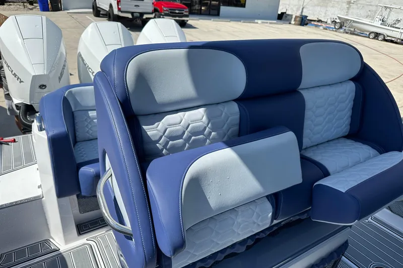 Slide: The Image of 2024 Nor-Tech 340 Sport Center Console with luxurious blue and white seating. - 6