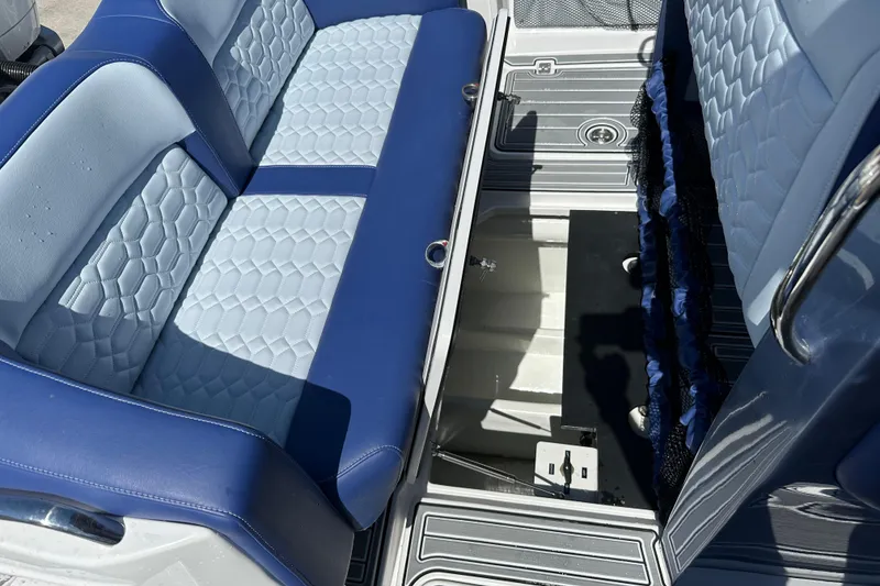 Slide: The Image of 2024 Nor-Tech 340 Sport Center Console interior with blue and light blue seating. - 8