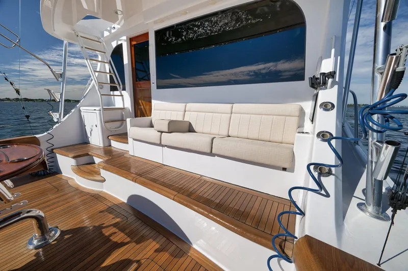 Slide: The Image of Luxury 2015 Hatteras GT70 yacht deck with polished wood and ocean view. - 18