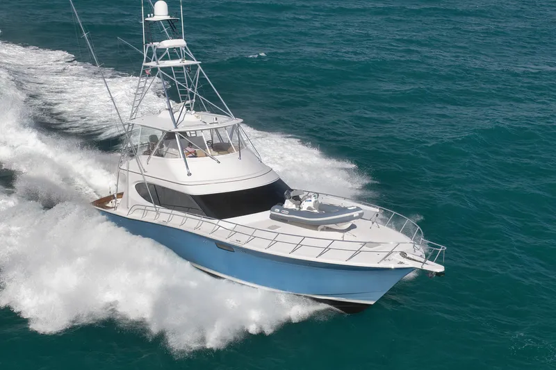 Slide: The Image of 2015 Hatteras GT70 yacht cruising on open ocean waters. - 2