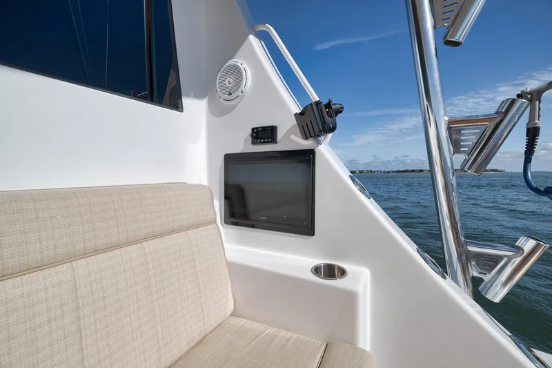 Slide: The Image of 2015 Hatteras GT70 yacht with open storage compartment, revealing food items and wooden deck. - 21