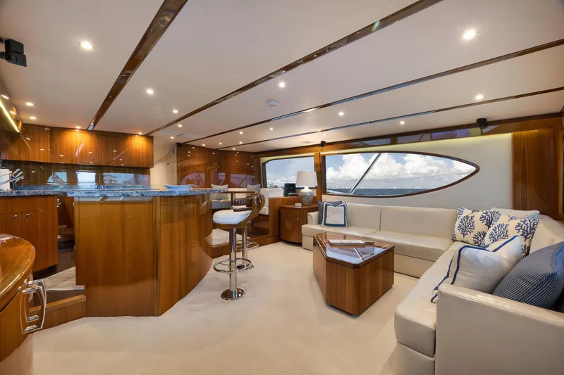 Slide: The Image of 2015 Hatteras GT70 yacht deck with wooden flooring and ocean view. - 26