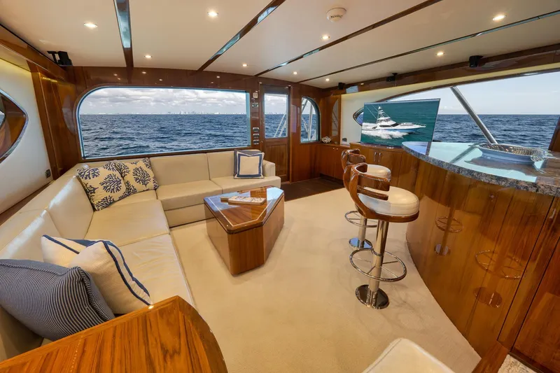 Slide: The Image of Luxurious interior of 2015 Hatteras GT70 yacht with ocean view, featuring elegant seating and decor. - 29