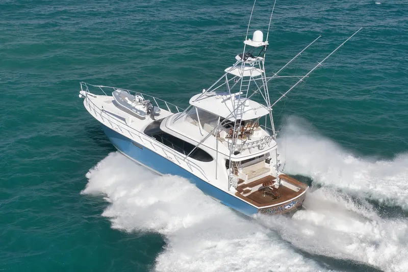 Slide: The Image of 2015 Hatteras GT70 yacht cruising on open ocean waters. - 3
