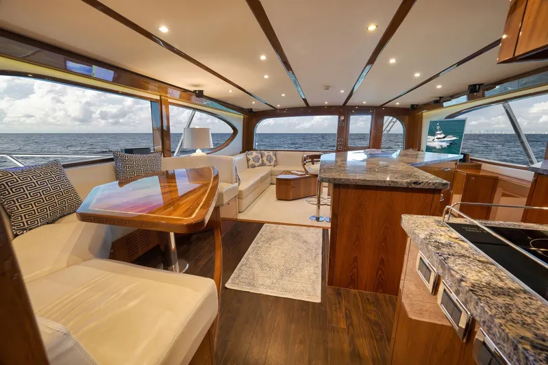 Slide: The Image of Luxurious 2015 Hatteras GT70 yacht interior with elegant wood finish and ocean view. - 32