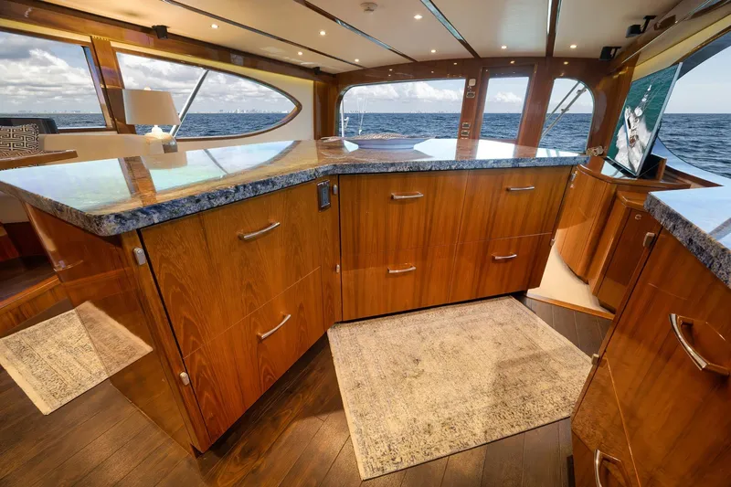 Slide: The Image of Luxurious 2015 Hatteras GT70 yacht interior with granite countertops and ocean view. - 34