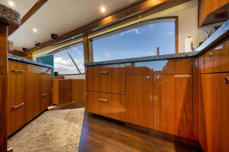Slide: The Image of Luxurious interior of 2015 Hatteras GT70 yacht with wooden cabinetry and ocean view. - 35