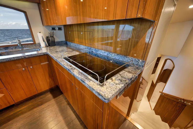 Slide: The Image of Luxurious interior of 2015 Hatteras GT70 yacht with polished wood cabinetry and ocean view. - 36