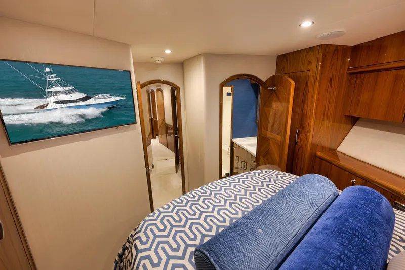 Slide: The Image of Luxurious cabin interior of 2015 Hatteras GT70 yacht with elegant bedding and wood finishes. - 48