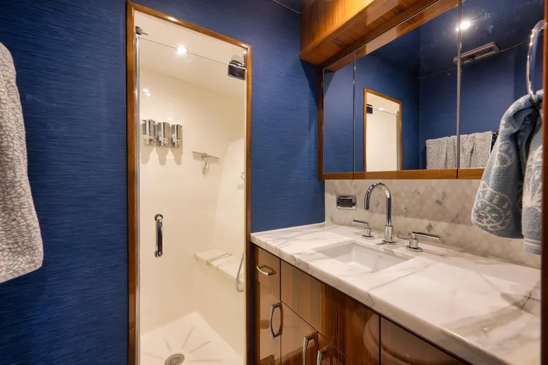 Slide: The Image of Luxurious 2015 Hatteras GT70 yacht interior with elegant wood finishes and modern amenities. - 49