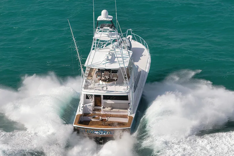 Slide: The Image of 2015 Hatteras GT70 yacht cruising on open blue waters. - 5