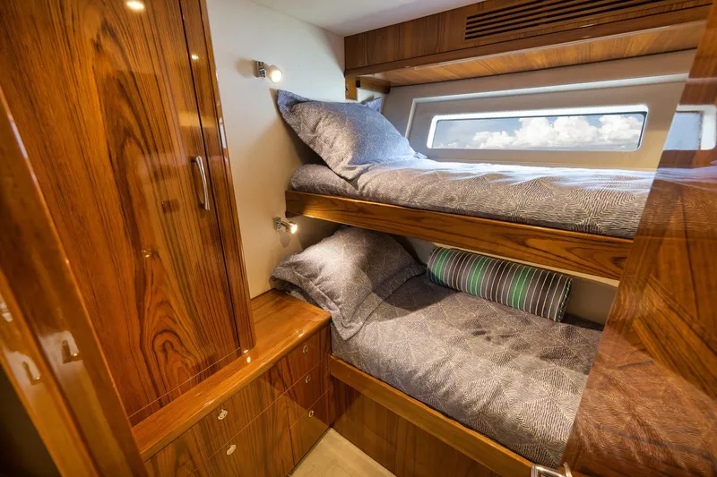 Slide: The Image of Luxurious wooden interior of 2015 Hatteras GT70 yacht with cozy bunk beds. - 51