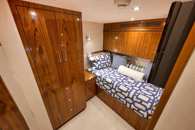Slide: The Image of Luxurious cabin interior of 2015 Hatteras GT70 yacht with patterned bedding and wall-mounted TV. - 55