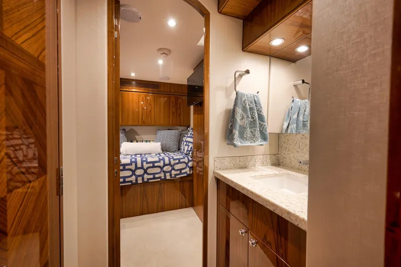 Slide: The Image of Luxurious cabin interior of 2015 Hatteras GT70 yacht with wood finishes and patterned bedding. - 56