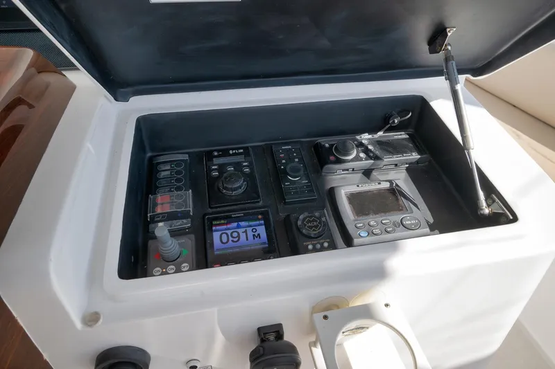 Slide: The Image of Control panel of a 2015 Hatteras GT70 yacht, featuring various gauges and switches. - 62