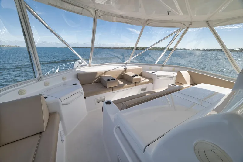 Slide: The Image of Luxurious 2015 Hatteras GT70 yacht helm with panoramic ocean views and elegant seating. - 66