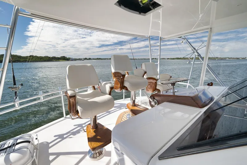 Slide: The Image of Control panel of 2015 Hatteras GT70 yacht, featuring navigation and monitoring instruments. - 74