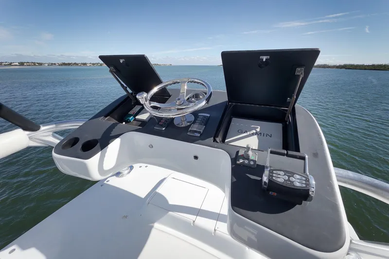 Slide: The Image of Helm of 2015 Hatteras GT70 yacht overlooking serene water. - 78
