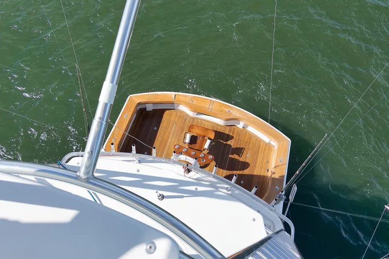 Slide: The Image of 2015 Hatteras GT70 yacht cruising on open water under clear skies. - 82