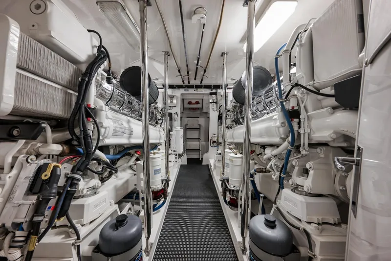 Slide: The Image of Engine room of 2015 Hatteras GT70 yacht, featuring dual engines and advanced equipment. - 84