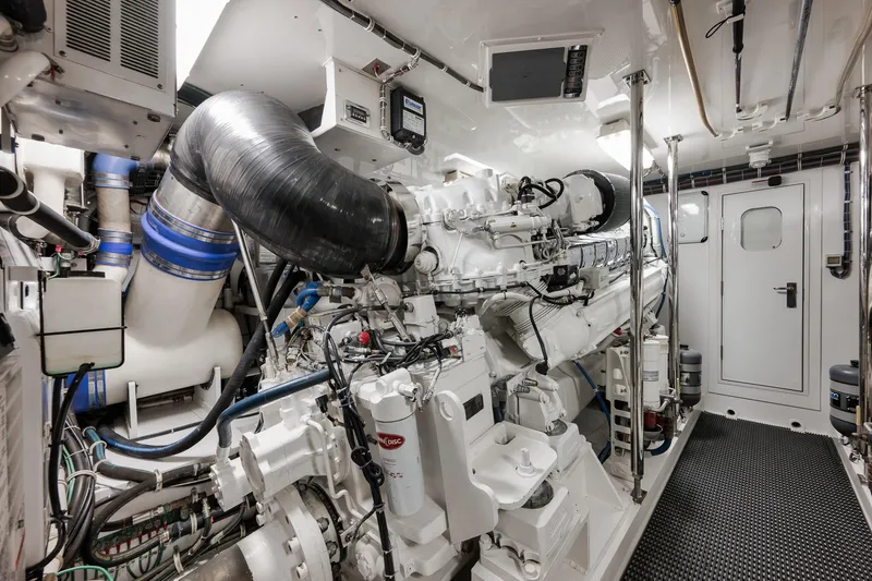 Slide: The Image of Engine room of 2015 Hatteras GT70 yacht, showcasing advanced machinery and equipment. - 85