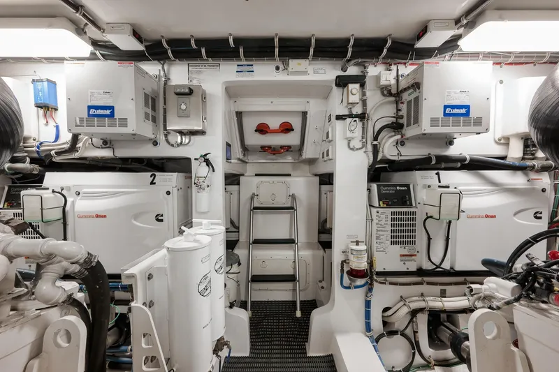 Slide: The Image of Engine room of 2015 Hatteras GT70 yacht, featuring advanced machinery and equipment. - 87