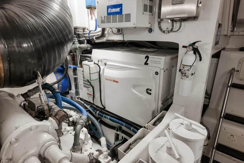 Slide: The Image of Engine room of a 2015 Hatteras GT70 yacht, showcasing advanced machinery and equipment. - 90