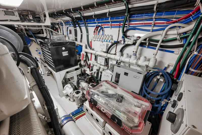 Slide: The Image of Engine room of 2015 Hatteras GT70 yacht featuring Cummins Onan generator and machinery. - 92