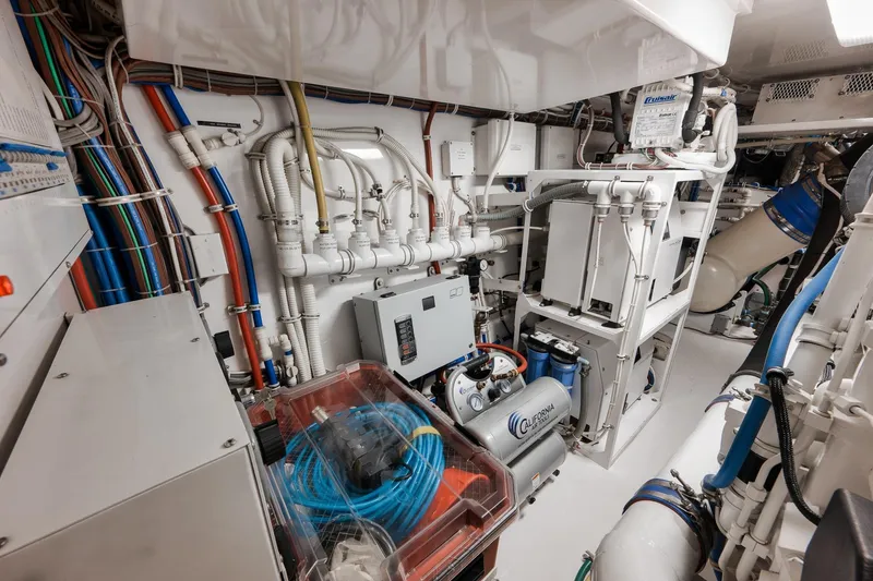 Slide: The Image of Engine room of 2015 Hatteras GT70 yacht with complex wiring and machinery. - 93