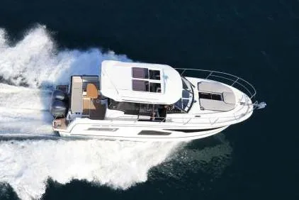 Slide: The Image of 2019 Jeanneau NC 1095 boat docked at marina, featuring sleek design and modern amenities. - 2