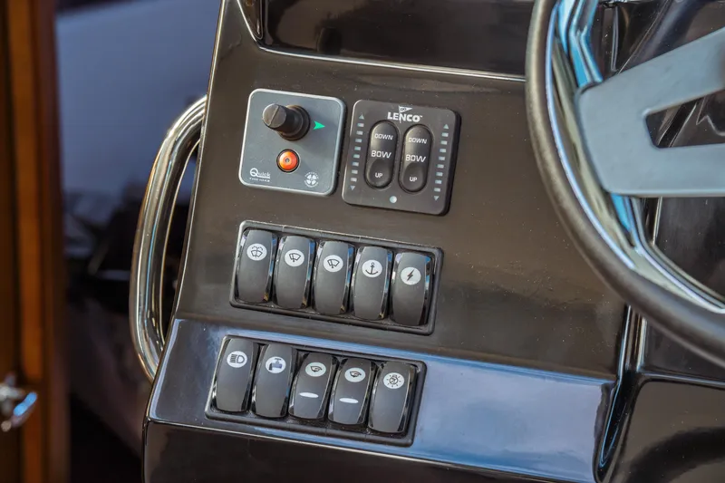 Slide: The Image of Control panel of 2019 Jeanneau NC 1095 boat with switches and steering wheel. - 29