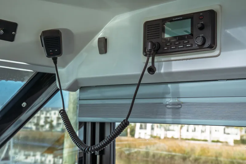 Slide: The Image of 2019 Jeanneau NC 1095 boat interior with Garmin radio and microphone setup. - 30