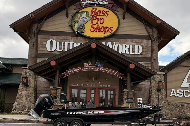 Slide: The Image of 2025 Tracker Savage 215 boat outside Bass Pro Shops Outdoor World store. - 10