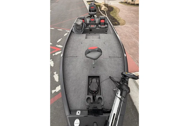 Slide: The Image of 2025 Tracker Savage 215 fishing boat interior with seating and trolling motor. - 6